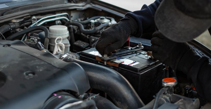 Mechanic replacing a car battery